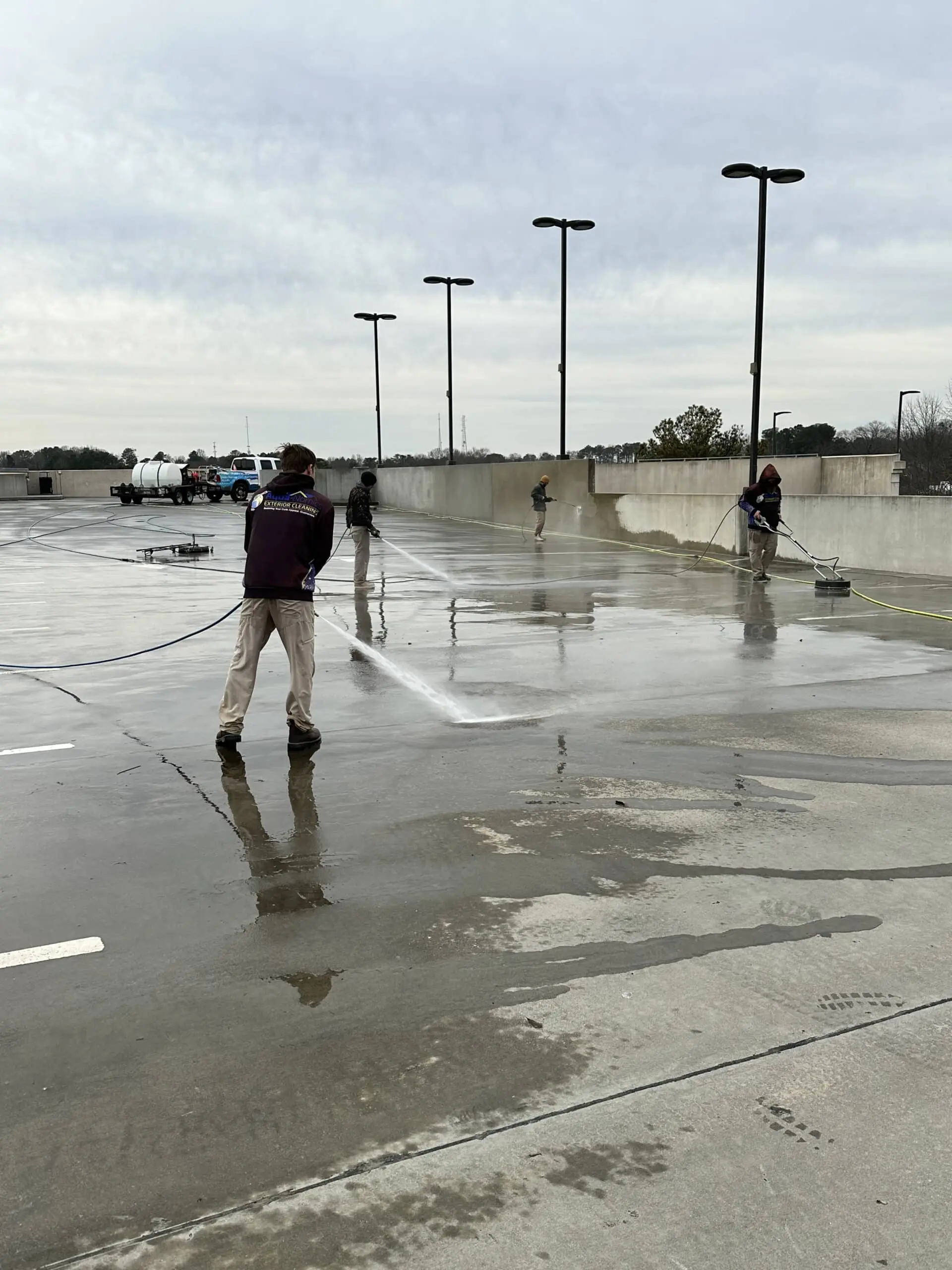 Parking Garage Pressure Washing Team Professional crew restoring cleanliness and safety to parking decks using advanced pressure washing for stain removal and long-lasting surface results