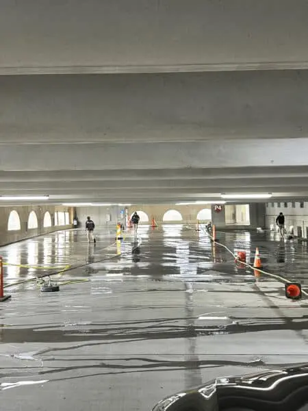 Team performs professional pressure washing on Alpharetta parking deck to eliminate grime buildup and ensure a spotless, safer driving surface
