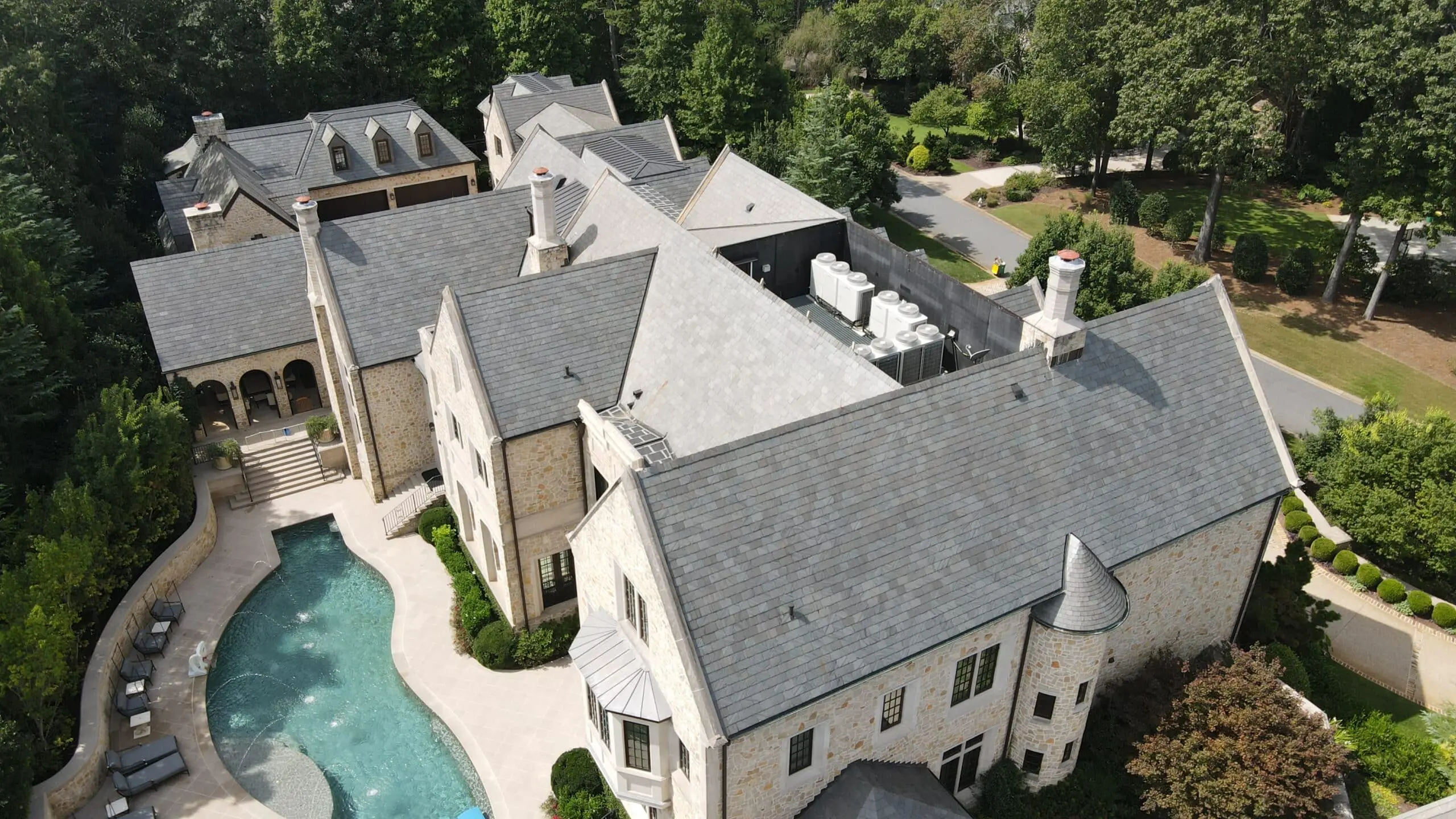 Clean Slate Roof on Luxury Estate Impressive aerial view of a luxury home with a pristine slate roof—expertly cleaned by Aqua-Nomics for lasting beauty and protection