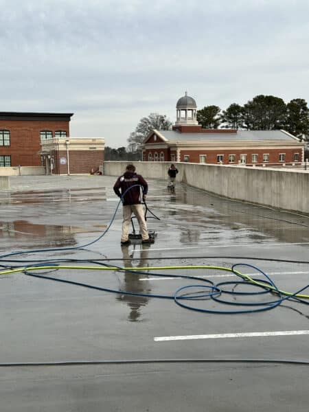 An Expert Holding A Hose For Cleaning